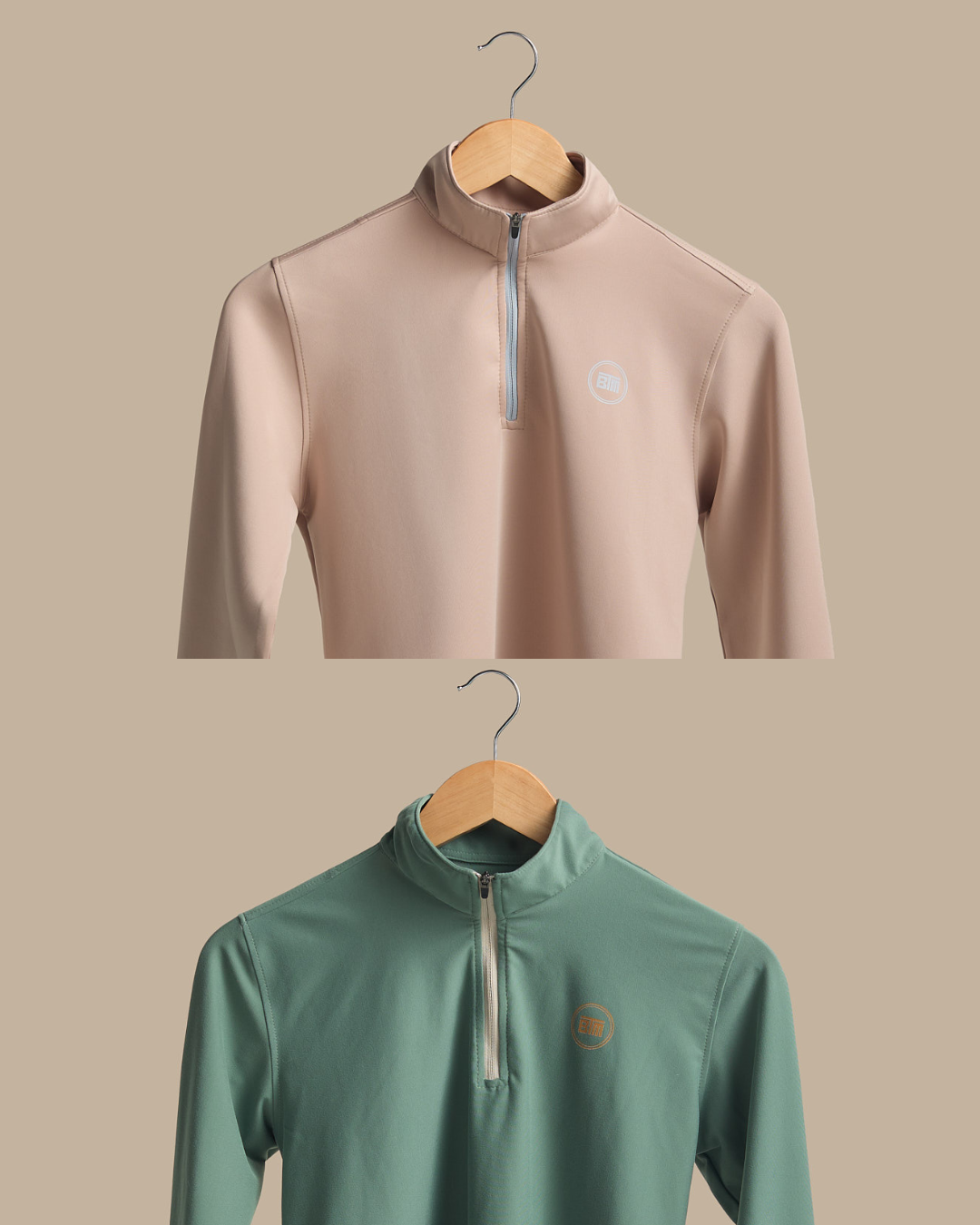 Two long-sleeve shirts on hangers against a beige background